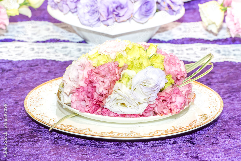 a cake composed of roses on the plate