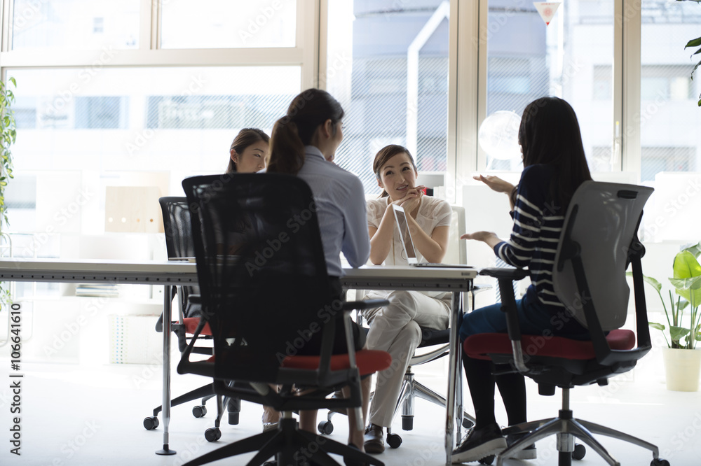 Four of the women have a planning meeting