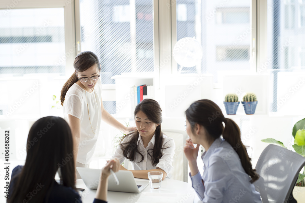 Women who are working in bright office