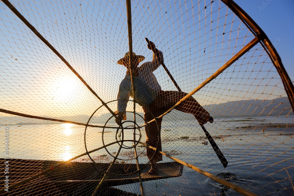 Fisherman silhouette with net at Inle lake