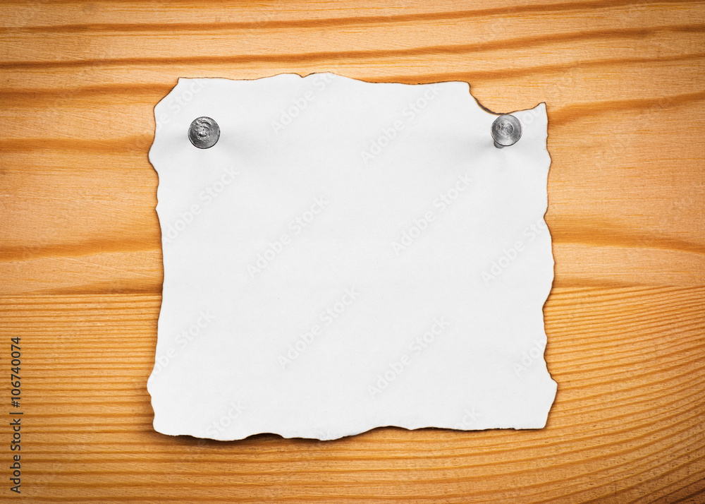 blank sheet of paper on a wooden board