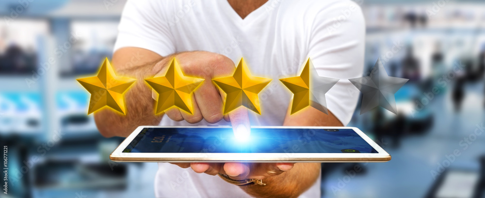 Businessman rating stars with his tablet