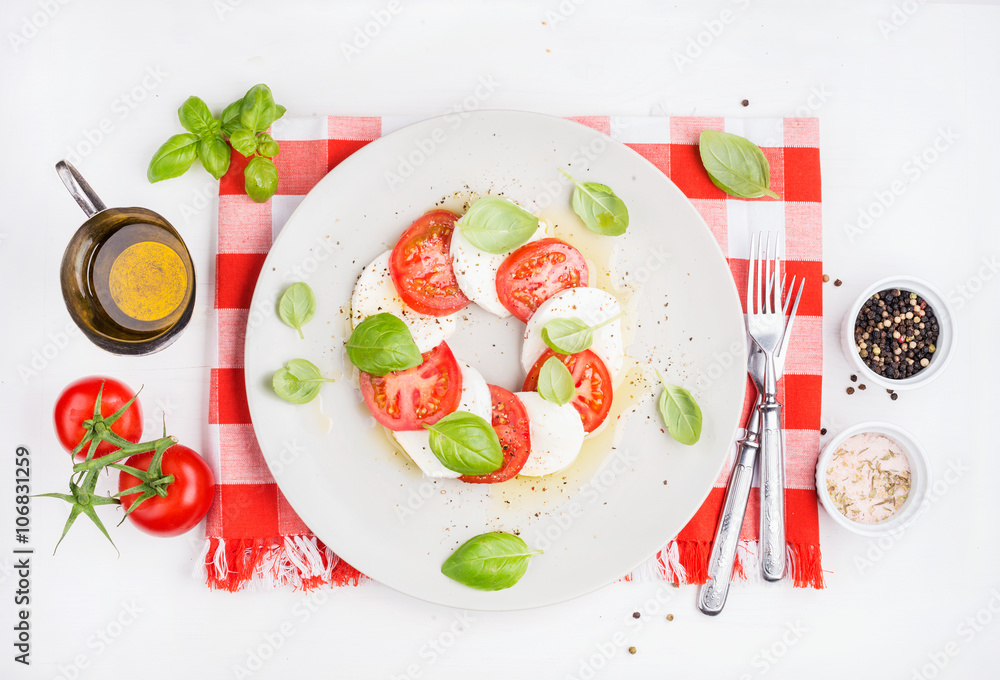 CLassic Italian Caprese salad with tomatoes, mozzarella di Buffala and fresh basil.