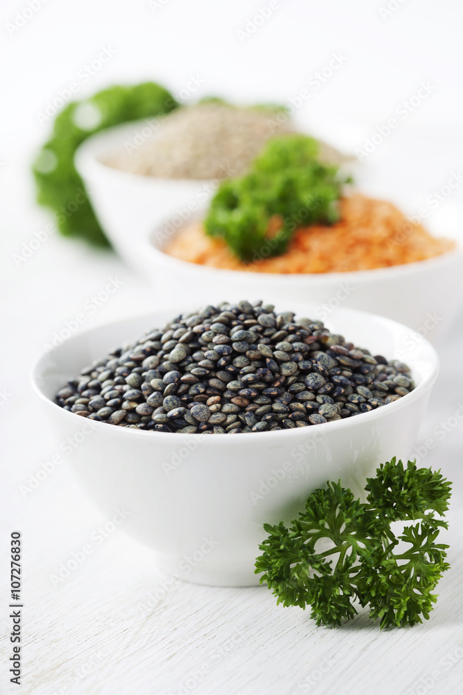 Bowls of assorted dried lentils with red lentils, black beluga l