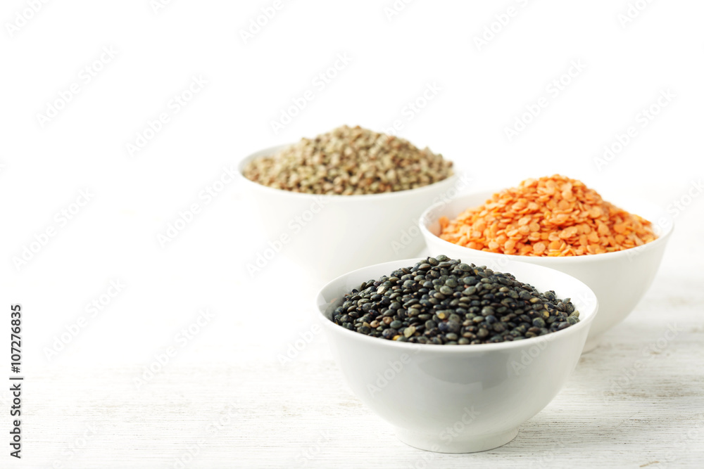 Bowls of assorted dried lentils with red lentils, black beluga l