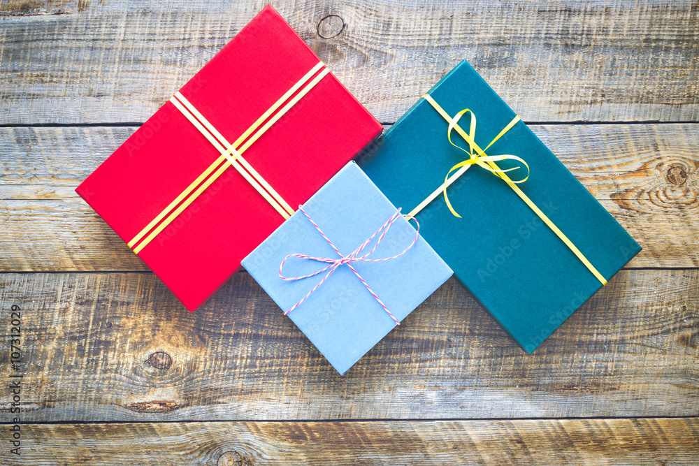 Colored gift boxes on wooden background