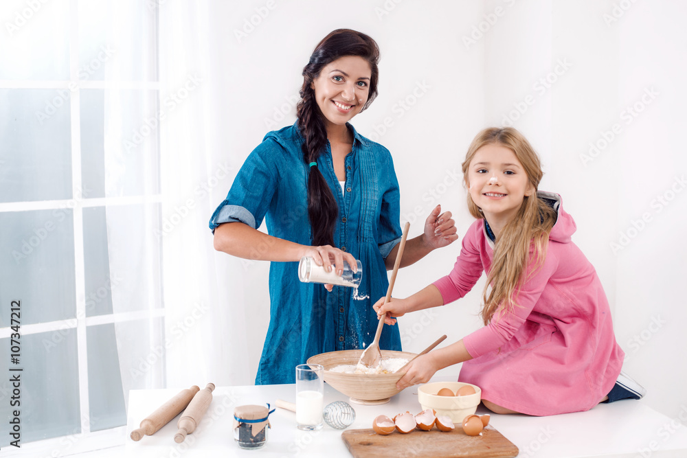 Happy mother and daughter baking