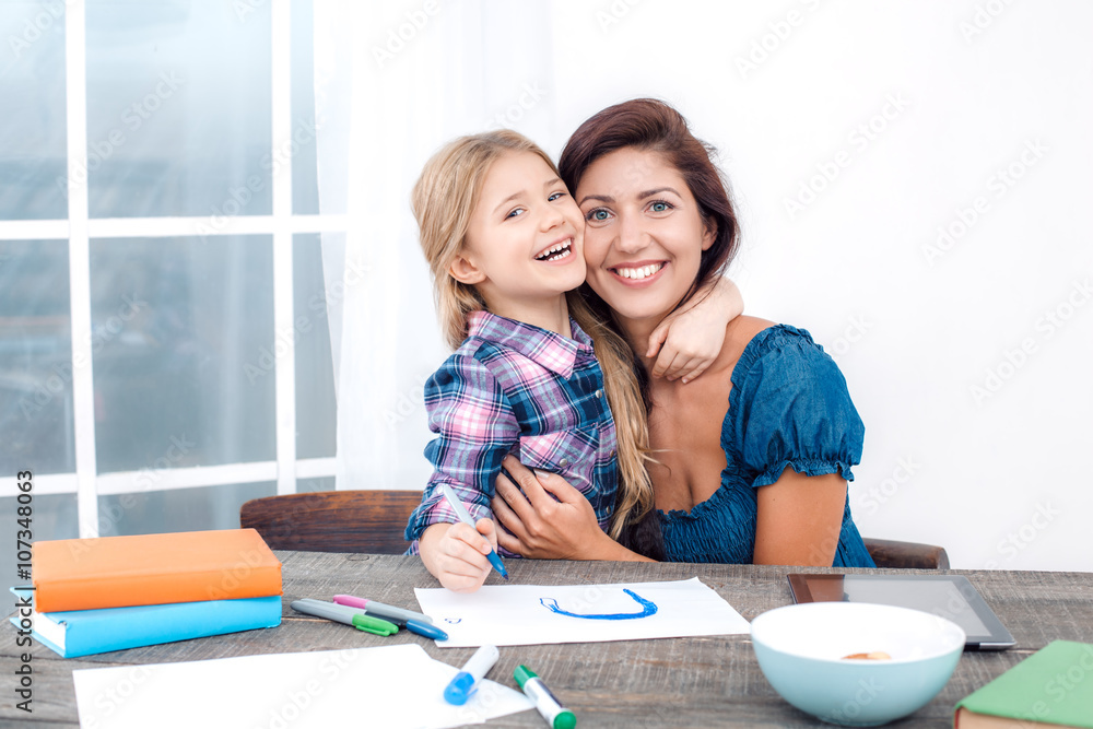 Happy mother and daughter at home