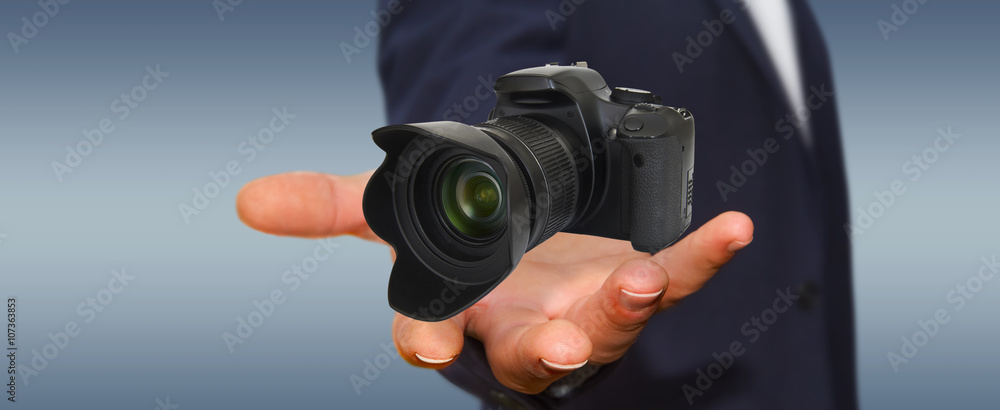 Young man using modern camera