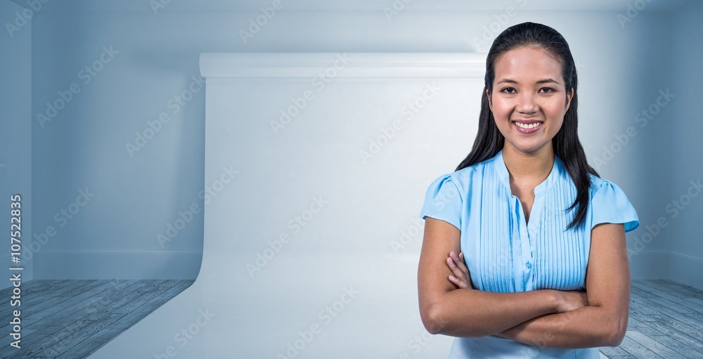 Composite image of smiling businesswoman with arms crossed