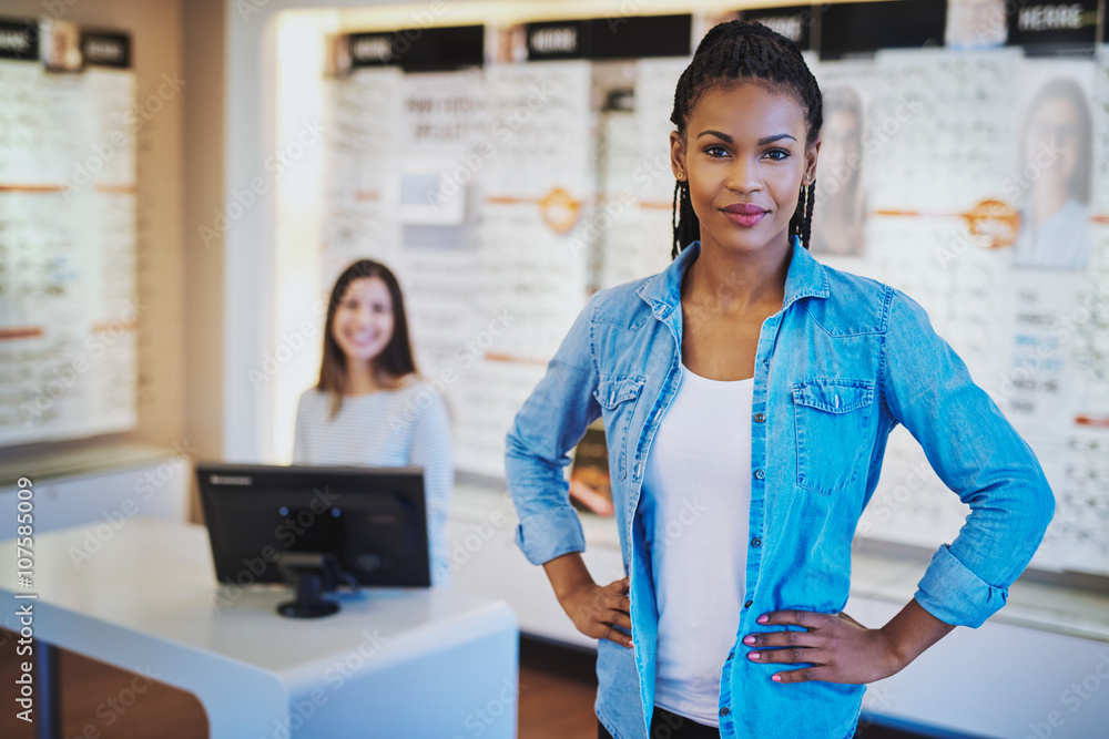 Young black woman smiling standing in her store