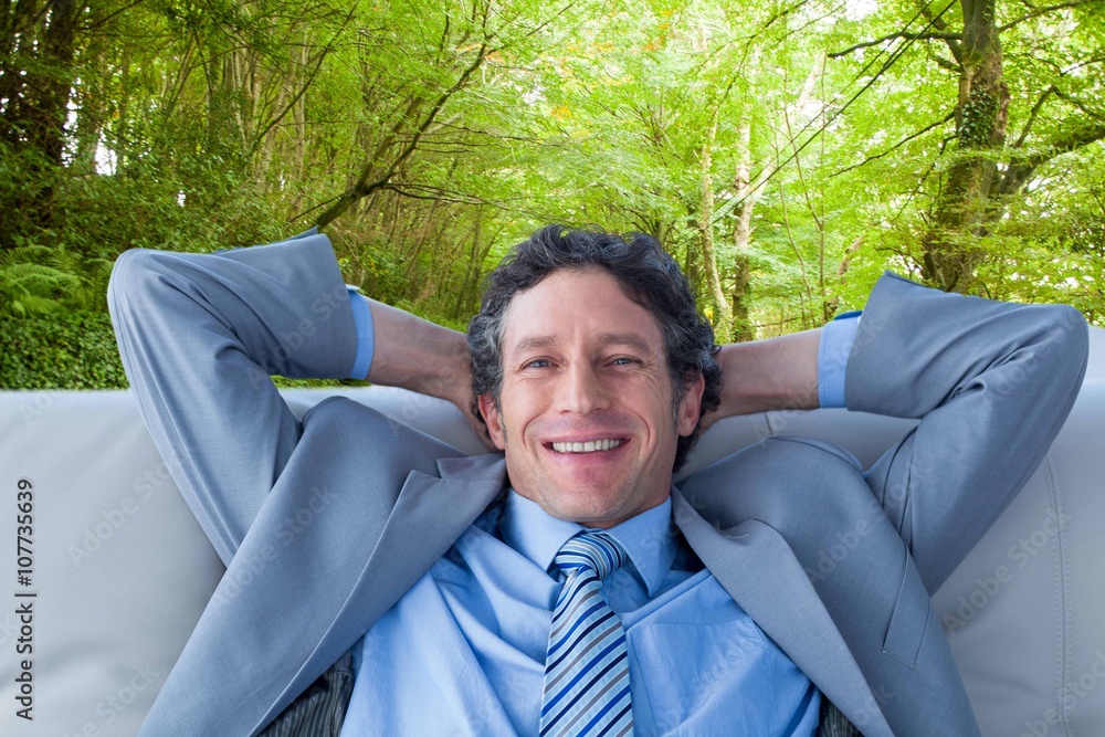 Composite image of businessman smiling at camera