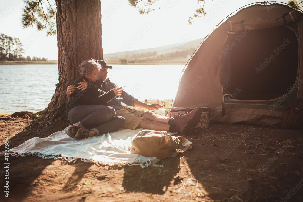 Loving senior couple camping near a lake