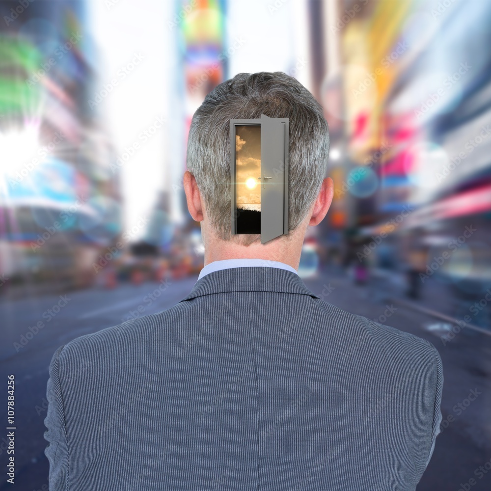 Composite image of rear view of businessman