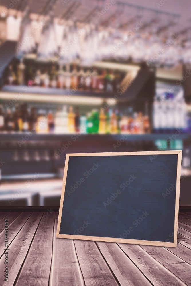 Composite image of wine glasses suspended on a rack