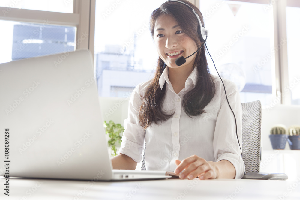 Young women are the correspondence of the customer with the headset