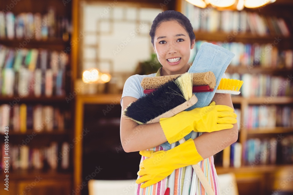 Composite image of woman nearly dropping her cleaning tools