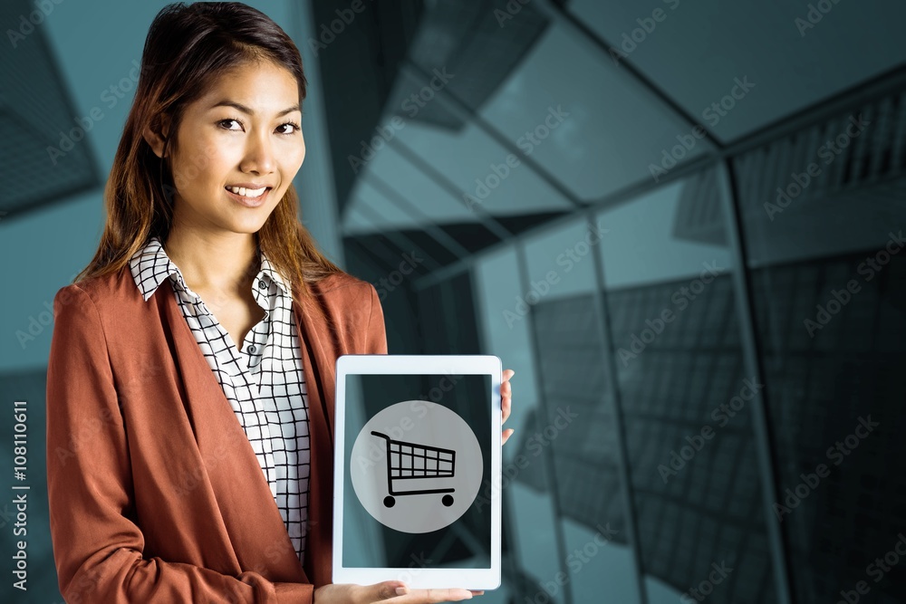 Composite image of smiling businesswoman showing a tablet