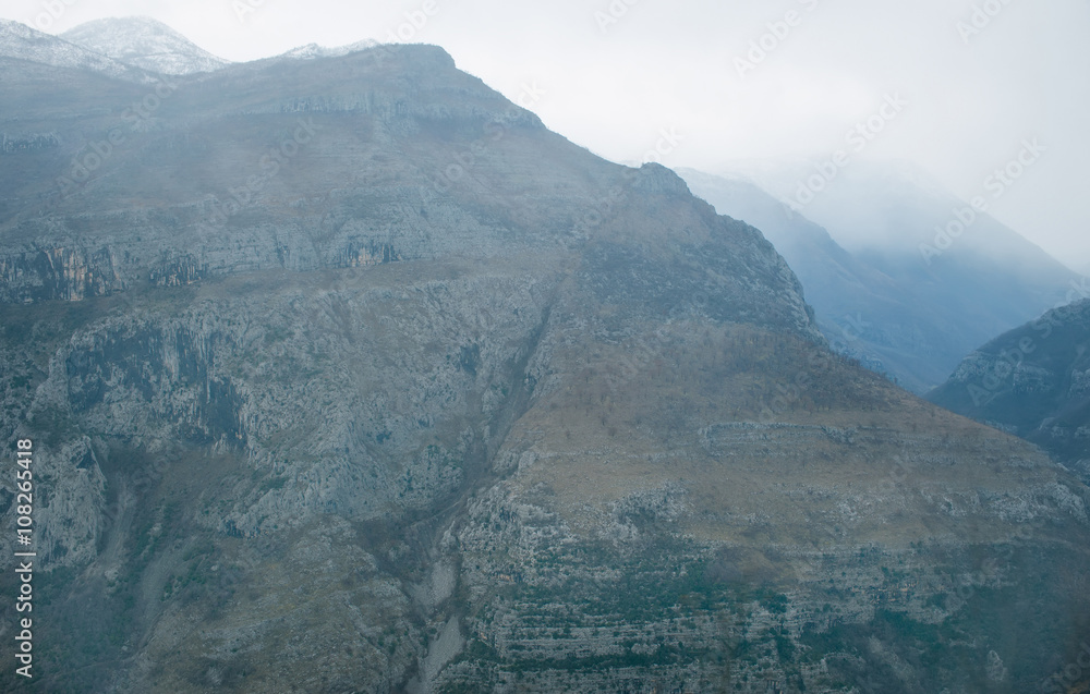 View over misty montain rock in the Moraca river canyon, north Montenegro, Balkan peninsula, winter.