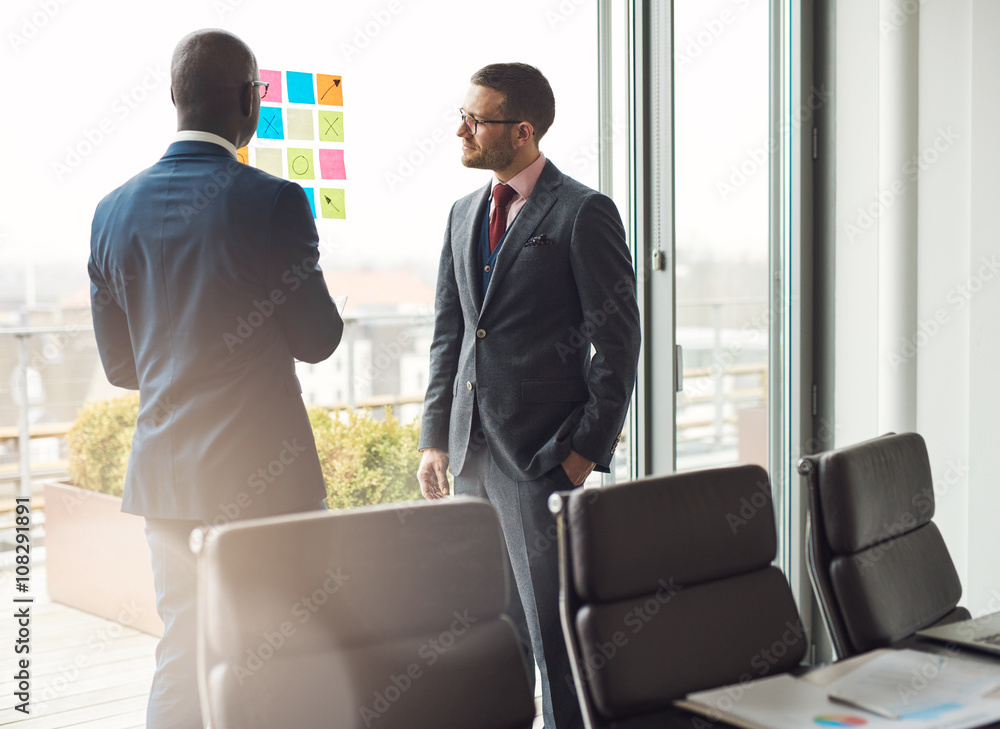 Two business man standing having a discussion