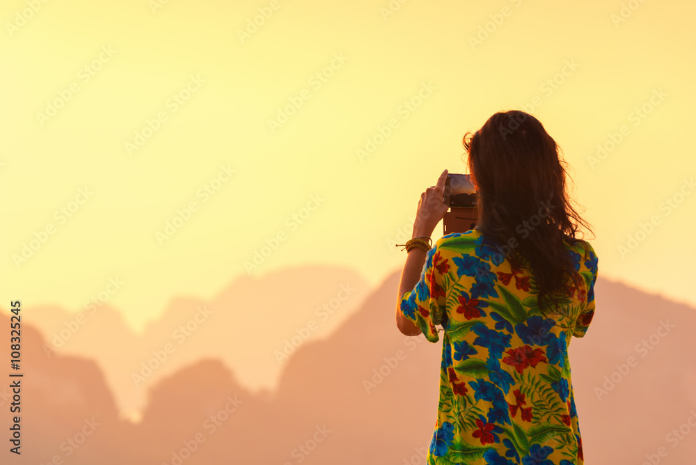 Rear view of woman taking photos of landscape view Phang nga island, Thailand. Travel concept.