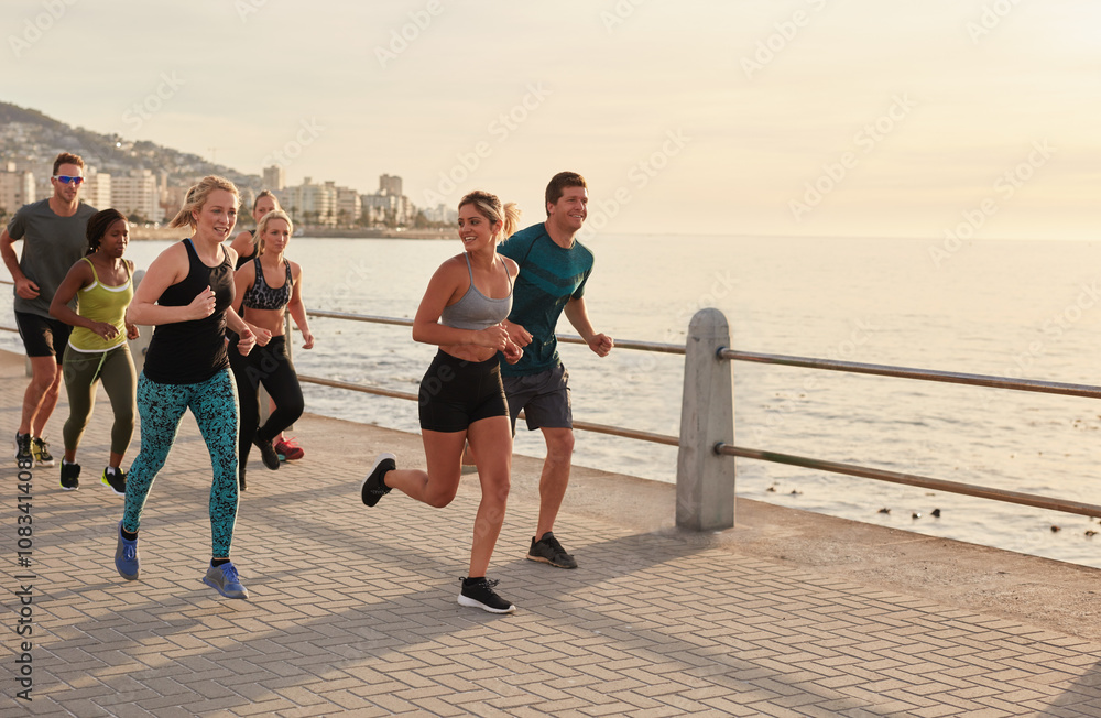 Young runners workout along a seaside promenade