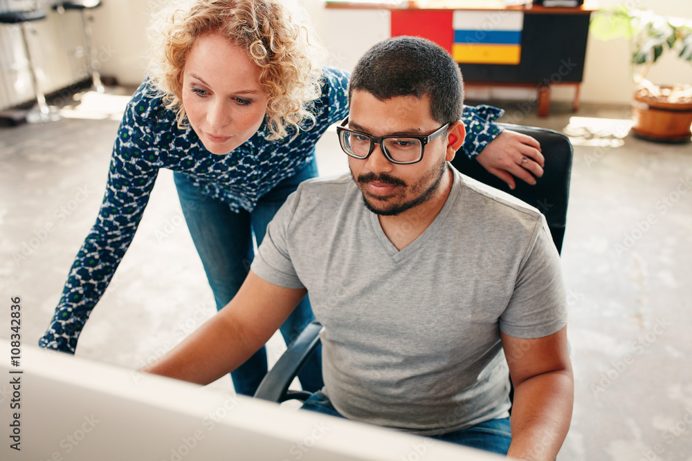 Graphic designers working on computer in office