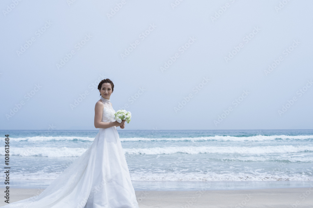 Bridere shooting the wedding photos on the beach