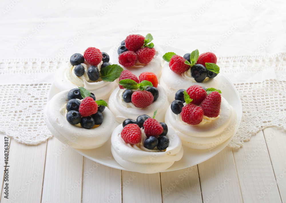 Homemade pavlova meringue cake with fresh berries and whipped cream. Morning. Dessert.