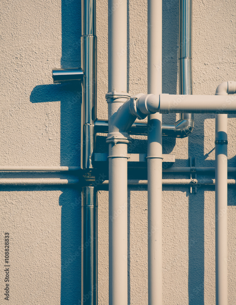 Pipeline water detail at industrial building wall