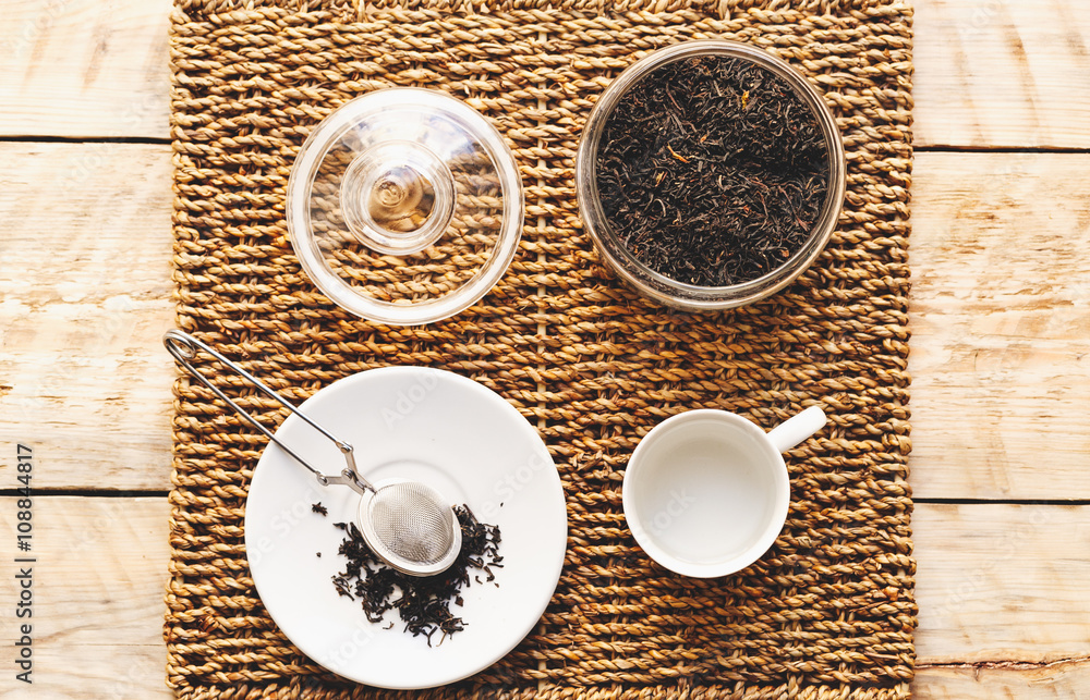 tea set with hot water in cup on wooden table