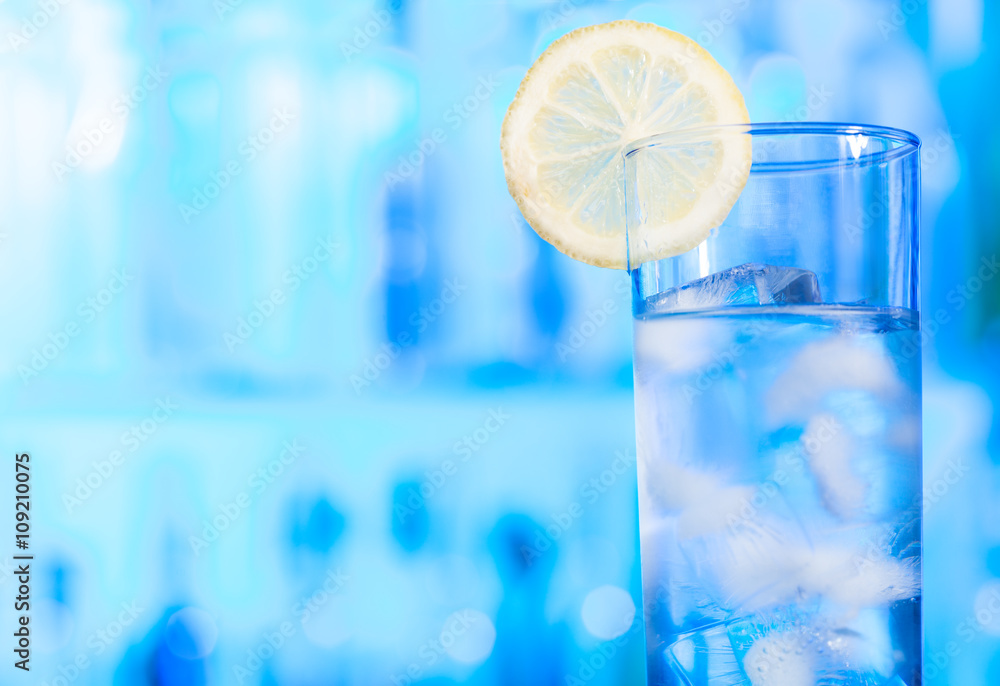 One glass of water with ice cubes and lemon slice