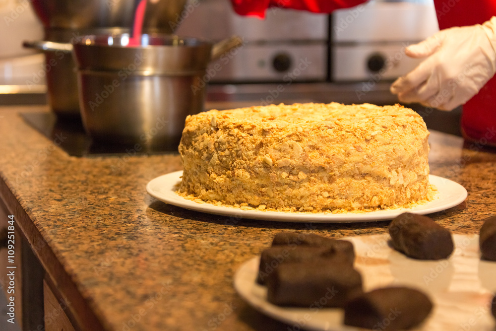 cooking cake decorating  in open kitchen of restaurant