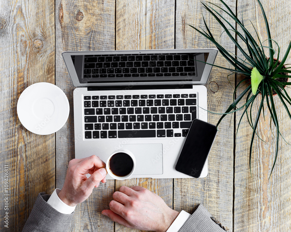 Comfortable mans working place at wooden table coffee break