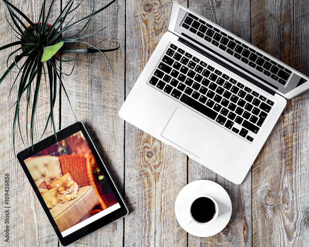 Comfortable working place at home with laptop on wooden table