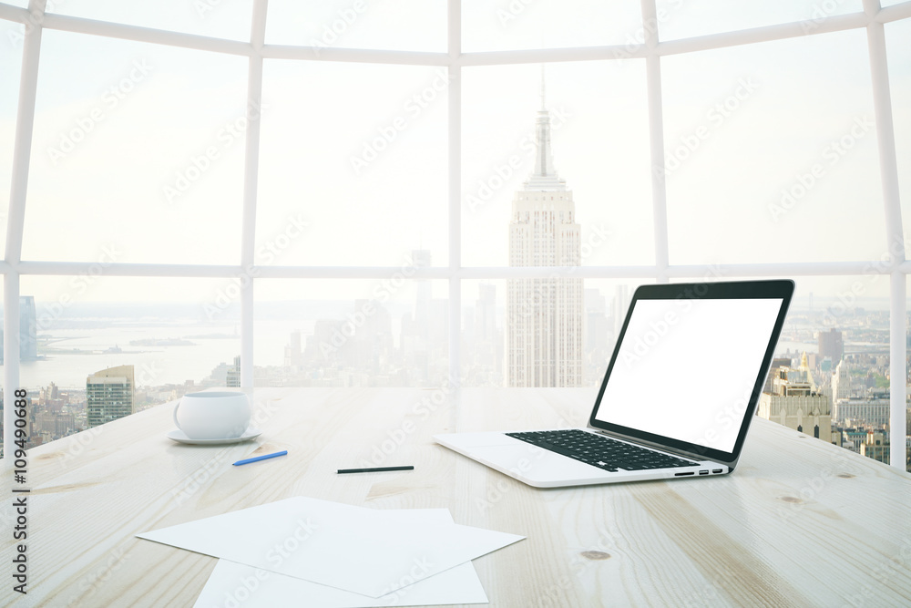 Light desk with white laptop