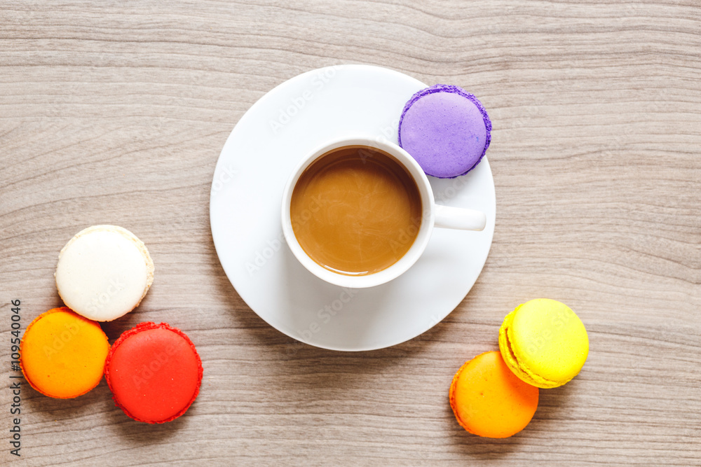 sweet breakfast with coffee and macaroons on wooden table