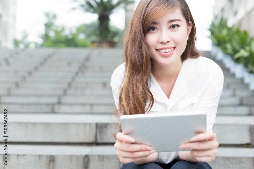 young beautiful asian girl with tablet in school