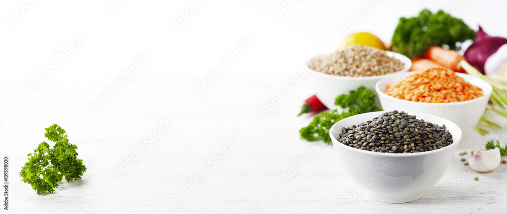 Bowls of assorted dried lentils with vegetables