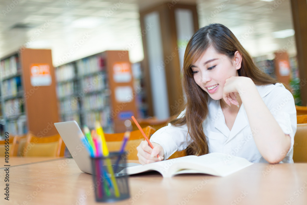 young beautiful asian girl student in library