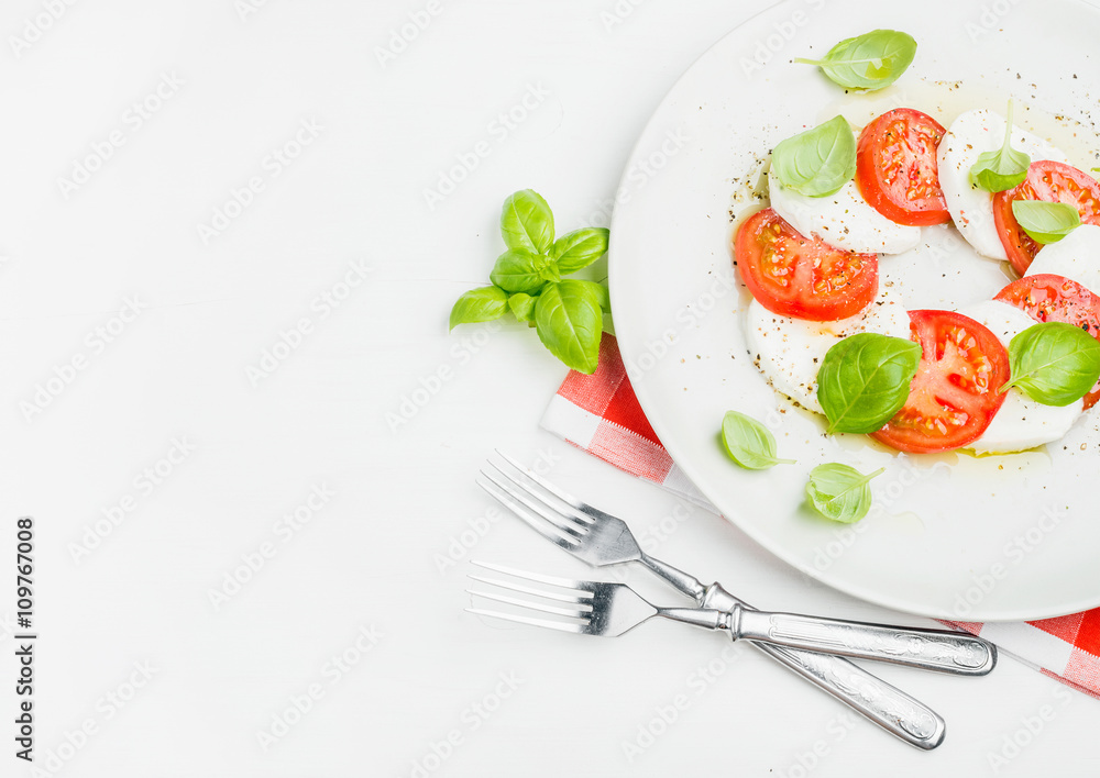 CLassic Italian Caprese salad with tomatoes, mozzarella di Buffala and fresh basil.