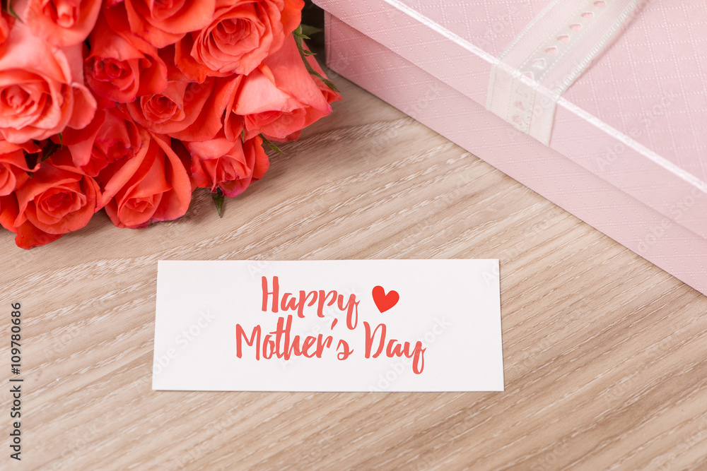 Happy Mothers Day. Greeting card and red rose on wooden backgound. 