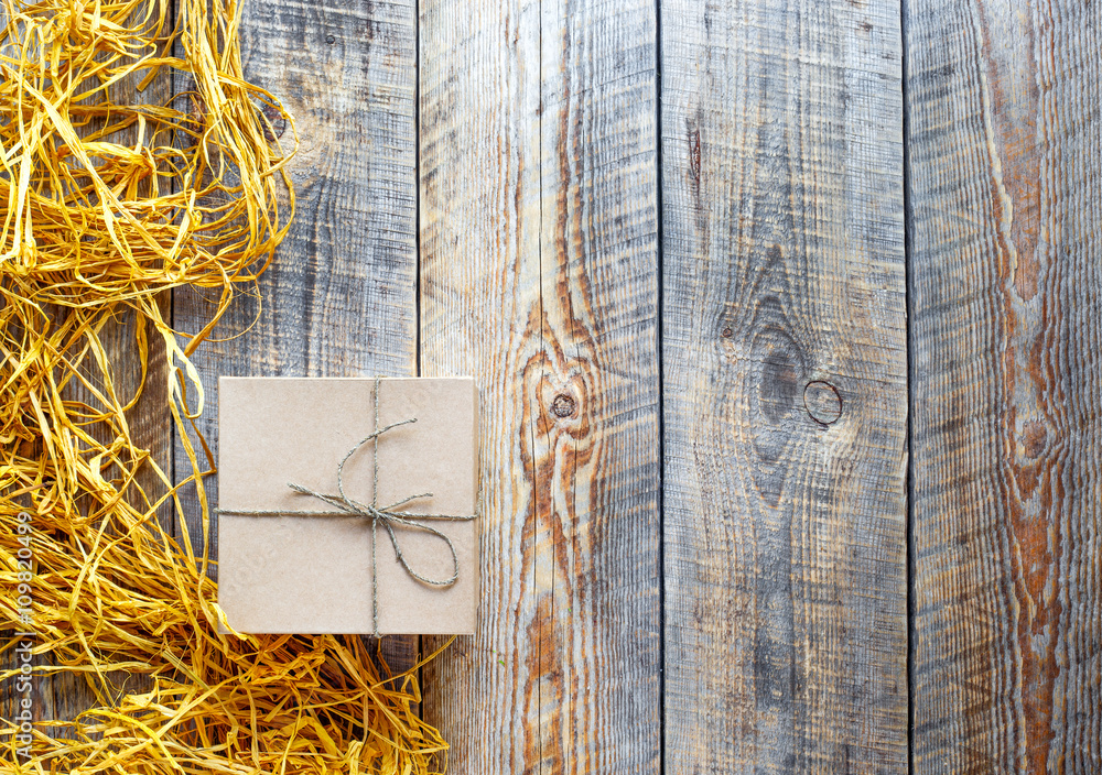 kraft gift box on wooden table with raffia or twine