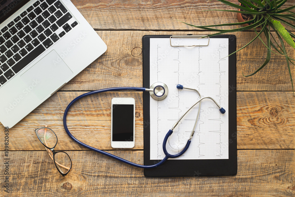 doctor workplace with a stethoscope at wooden table