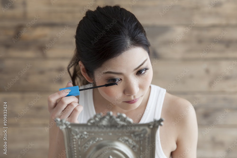 Young women are painted with mascara to the eyelashes