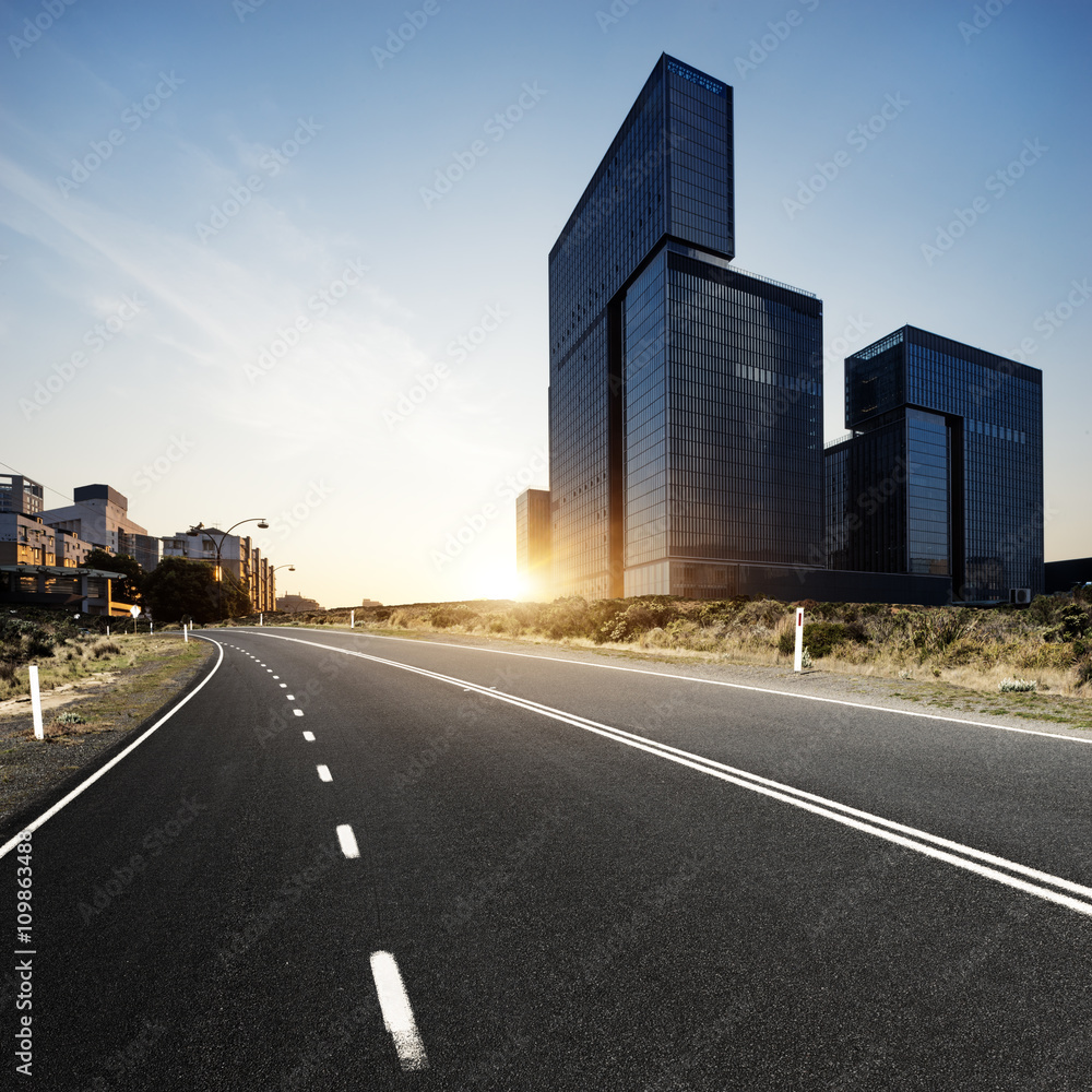 urban road in modern city at sunrise