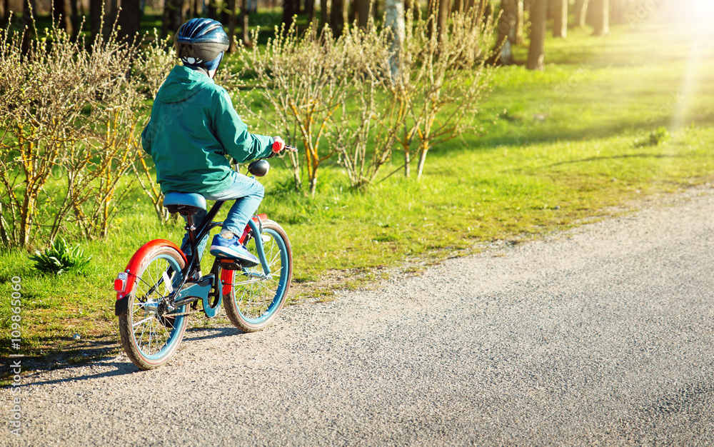 child on a bicycle at asphalt road