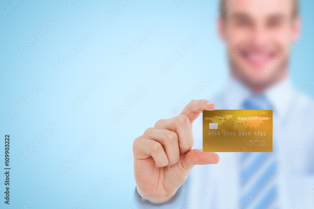 Composite image of happy businessman showing a creditcard