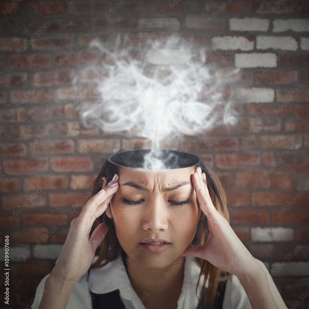 Composite image of nervous businesswoman holding her head