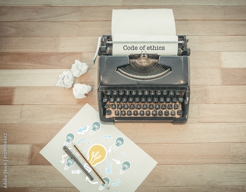 Code of ethics against typewriter and paper on table in office